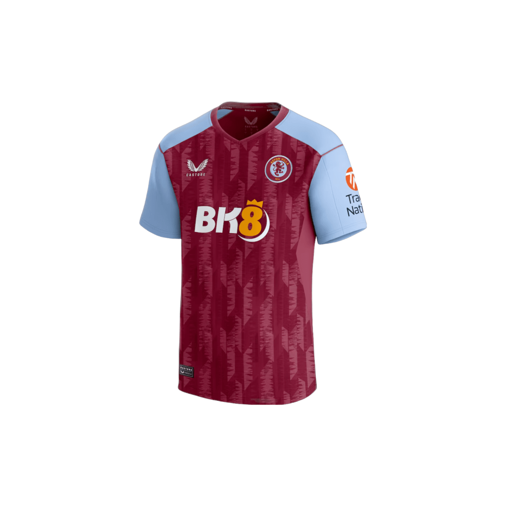 A red Aston Villa 2023-2024 soccer jersey with blue sleeves. The jersey has the words "Aston Villa" and "CASTORE" printed on it. The text "Tra Nati" and "BK8" are also printed on the jersey.